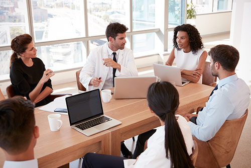 A nursing student conversing with faculty