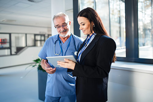 A nursing student conversing with faculty